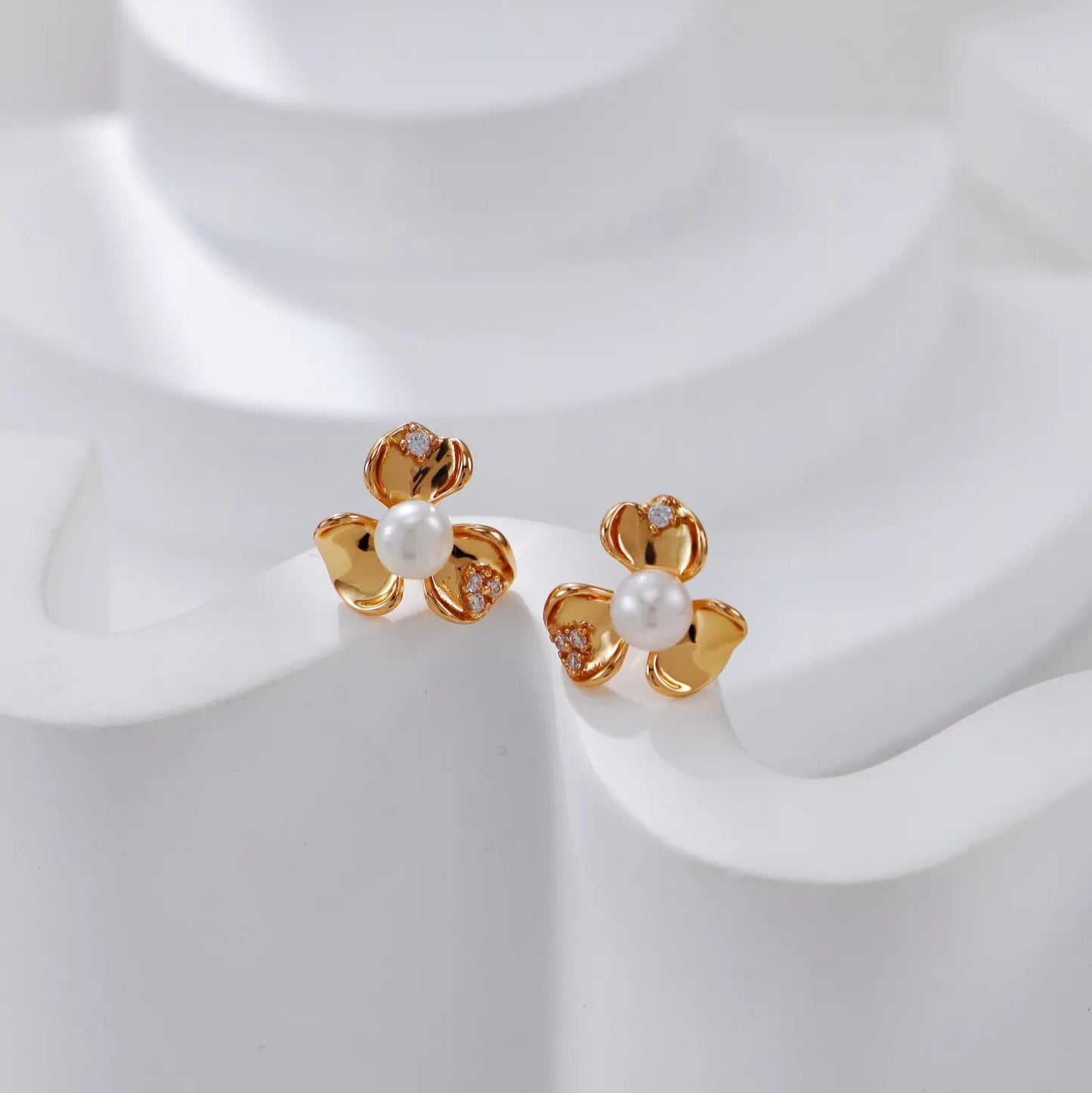 S925 Silver Petal Zircon Earrings in gold on white curved stand