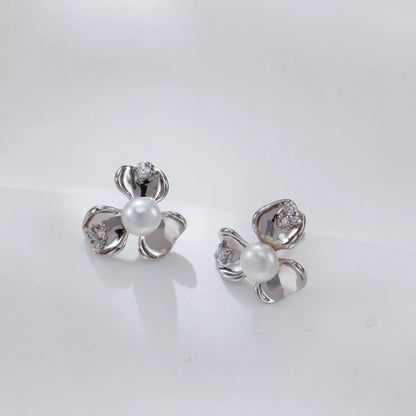 Silver Petal Zircon Earrings in gold on white curved stand
